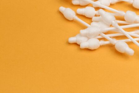 cotton buds close-up on a light yellow background, for children, hygiene and ear cleaning, cotton...