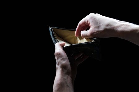 hand with empty wallet isolated on black , bankruptcy, debt, mortgage conceptの写真素材