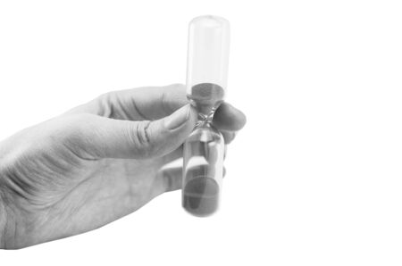 hand holding hourglass isolated on white background, black and white, sandglass