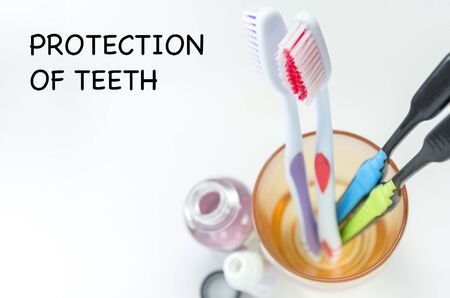multi-colored toothbrushes in a glass on a light background top view, selective focus, mouthwashの写真素材