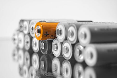 alkaline AA batteries on the glass surface with close-up reflection, salt batteries, accumulators
