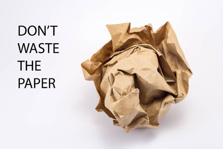 crumpled into a lump craft paper isolated on white background with inscription donât waste the paper, forest conservation conceptの写真素材