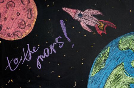photo of drawing chalk on the board rocket flying from earth to the Mars, the journey to the Mars