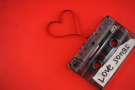 vintage old film music cassette on a trendy pink background with the inscription love song, background music, music lovers, heartの写真素材