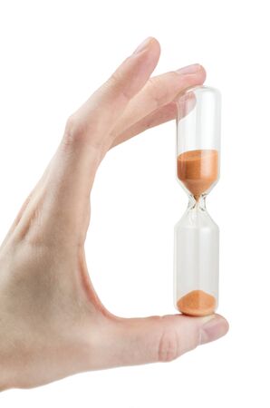 hand holding hourglass isolated on white background, sandglassの写真素材