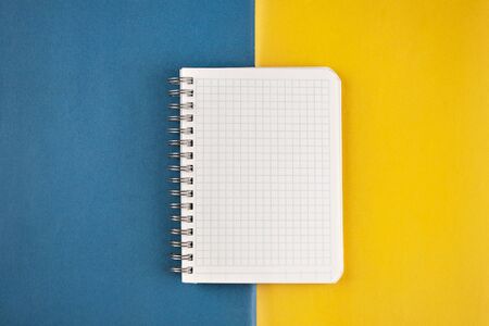 Notepad open on a blank page against a blue-yellow background