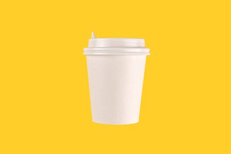 coffee cup cardboard disposable isolated on yellow background, coffee to go, takeawayの写真素材
