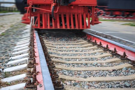 rails for trains close-up selective focus, against the background of the train coming towards,...