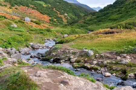 green hilly area, green mountains and mountain river, autumn mountain landscapeの写真素材