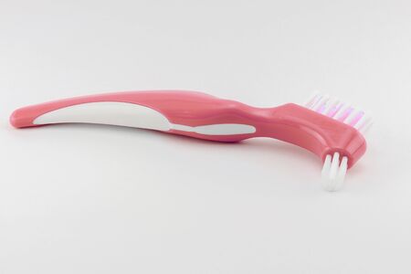 hard brush for cleaning and rinsing removable dentures, care and treatment of plastic dentures daily at homeの写真素材