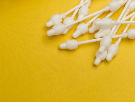 cotton buds close-up on a light yellow background, for children, hygiene and ear cleaning, cotton...