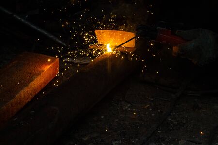 the work of the welding machine in the hands of the welder, welding sparks, industrial backgroundの写真素材