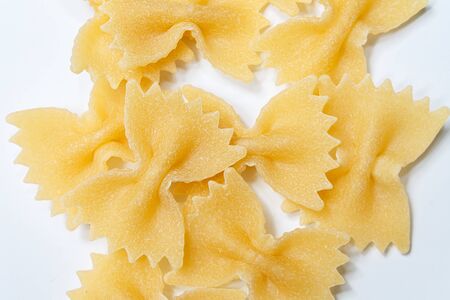 pasta from durum wheat farfalle, bows, unprepared, raw pasta handmade on white background isolated