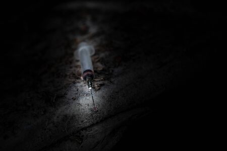 used disposable syringe thrown on the street, anti-drug, destructive addiction, anti-drugの写真素材