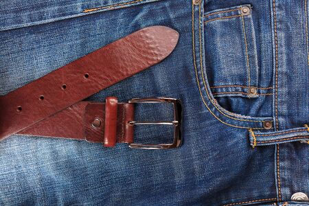 men's leather trouser belt in the background of denim, men's closet, jeans