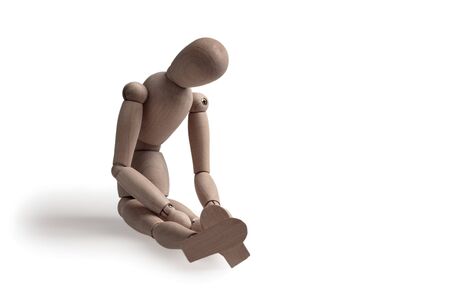 human figurine depicting a lonely bored person, the concept of abandonment and uselessness, despair and depression, autism, mental disordersの写真素材