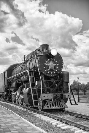 vintage steam train on the rails close-up, retro vehicle, steam engine, black and whiteの写真素材