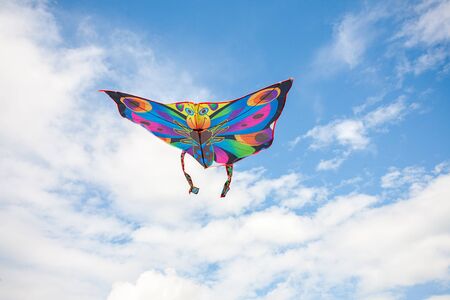 kite in hand against the blue sky in summer, flying kite launching, fun summer vacationの写真素材