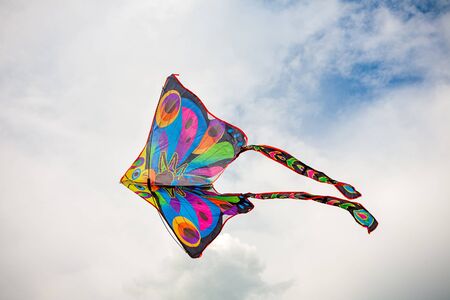 kite in hand against the blue sky in summer, flying kite launching, fun summer vacationの写真素材
