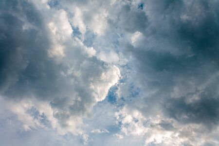 rays of the sun through the blue stormy skyの写真素材