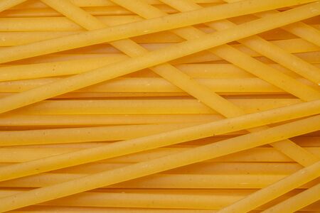 macaroni unprepared raw rope tied spaghetti from durum wheat handmade isolated macro, close up