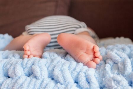  newborn baby legs in baby cot, the concept of motherhood fatherhood, child careの写真素材