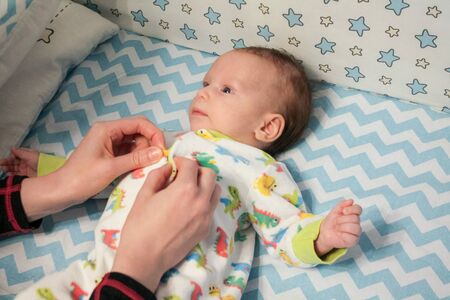 dressing of the newborn, clothes for the small child of the baby, overalls without buttons on rivets