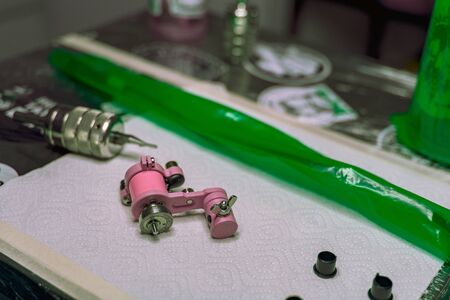 tattoo machine close-up on the table at the tattoo master prepared before the session, tattoo salon, safety of the procedureの写真素材