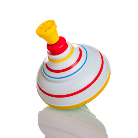 children's toy top isolated on a white background, color beautiful bundle, mobile toy for little kids, spinning top, gyroscope, design, copy spaceの写真素材