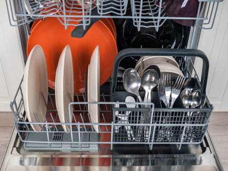 dishwasher close-up with washed dishes, easy to use and save water, eco-friendly, built-in kitchen dish washing machine, selective focus