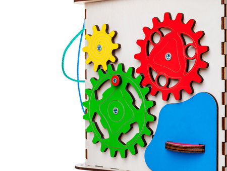 children's educational toy busycube, busyboard, isolated on a white background, the development of motor skills and coordination in kids, design, copy spaceの写真素材