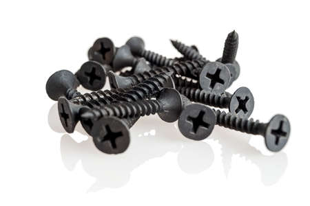 A set of metal self-tapping screws, black, sharp screws, isolated on a white background, close-up