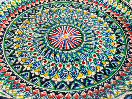 Plate with an oriental theme pattern, bright beautiful, close-up, solid backgroundの写真素材