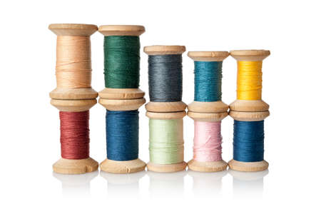 Many different, multi-colored coils, bobbins, skeins of thread for sewing and embroidery, weaving,...