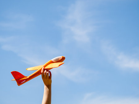 A bright colored airplane against the background of a clear blue sky is going to take off, vacation, travel, opening bordersの写真素材