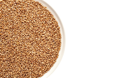 Kernel of grits from whole undivided buckwheat grains, in a plate, close-up, fried buckwheat, having a brown tintの写真素材