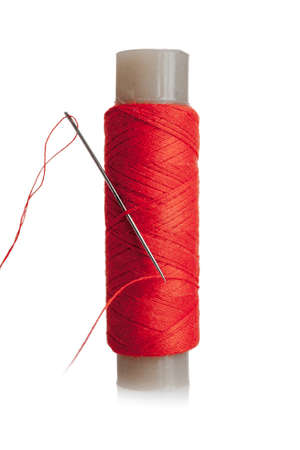 A skein of red thread for sewing and repairing clothes, a spool with cotton, synthetic threads,...