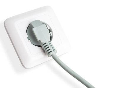 Wall-mounted electrical socket for connecting an electrical plug from appliances device socket isolated on a white background close-upの写真素材
