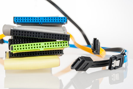 outdated cable ide sata cable for connecting hard drives and drives in a computer for data storage close-upの写真素材