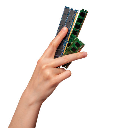 Hand holding RAM modules to assemble a computer, choosing the right components for a computer, types of RAM isolated on a white backgroundの写真素材
