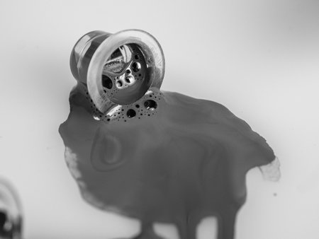 A jar with spilled red paint, paint background, pigments, ink for tattooing, close-upの写真素材