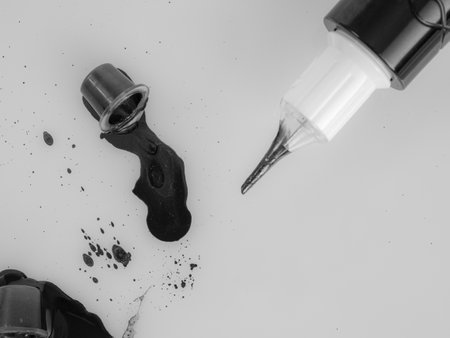 Tattoo machine for tattooing , permanent makeup, with jars of paint, close-up needle, selectiveの写真素材