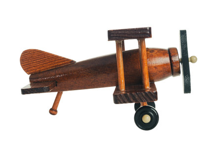 Wooden toy airplane for children's games, vintage retro style, isolated on white background, close upの写真素材