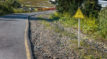 Road sign warning about a sharp turn in a mountainous area, closed natural area, national park close-upの写真素材