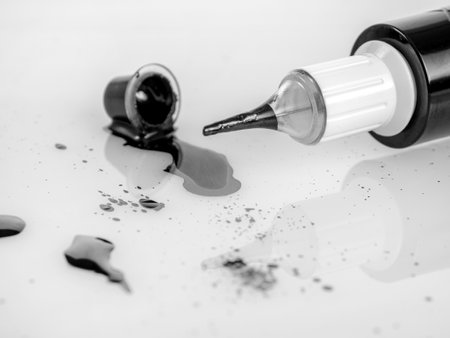 Tattoo machine for tattooing , permanent makeup, with jars of paint, close-up needle, selectiveの写真素材