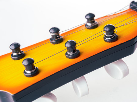 Acoustic guitar with strings for playing musical pieces, tuning the guitar close-up