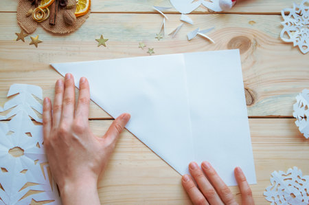 cutting out snowflakes from paper, New Year decorations toys, Christmas preparations at home, selective focus, close-upの写真素材