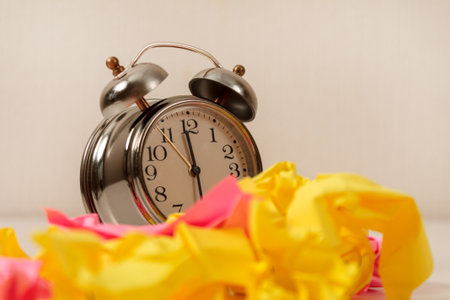 Alarm Clock and Stickers: An alarm clock set against a backdrop of many colorful sticky notes,...