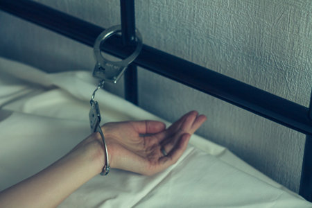 In the photo, a woman's hand is handcuffed, like the embodiment of unfreedom and suppression, where...