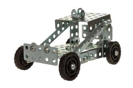 Metal Model Car Construction Set: A buildable metal model car with crisp angular shapes, perforated plates and visible fasteners. Realistic details and moving parts such as rotating wheels. Durable and engineering-accurate design.の写真素材